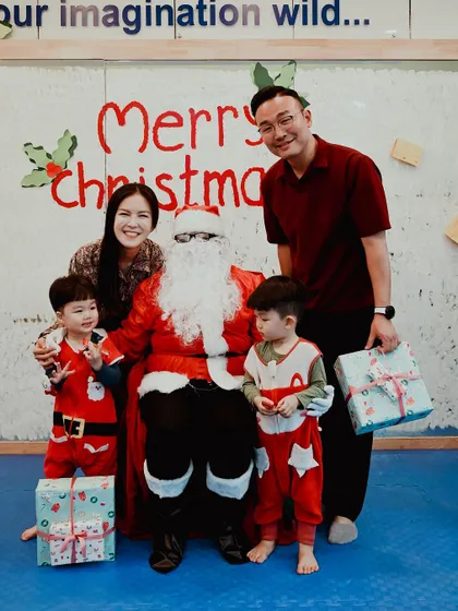 Two brothers in their Christmas pajamas get their photo taken with Santa.