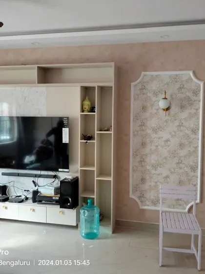 A living room feature wall combining a textured damask wallpaper with a paneled section for a classic look.