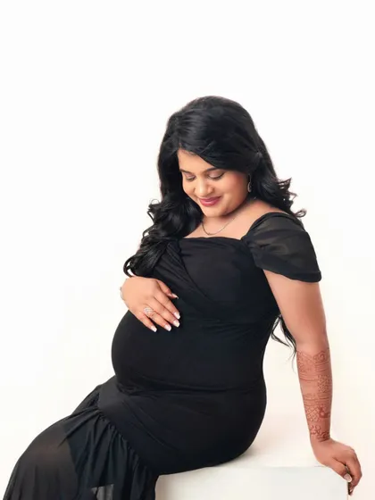 This pose shows off the beautiful curves of pregnancy. The simplicity of the dress and background keeps the focus on her.