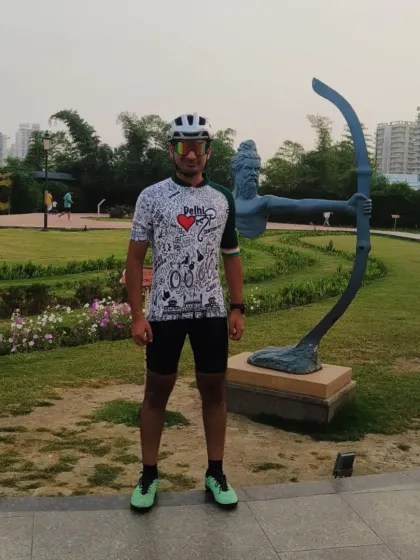 A rider in our signature jersey posing with a sculpture at Ved Van. Our themed rides are full of great photo opportunities.