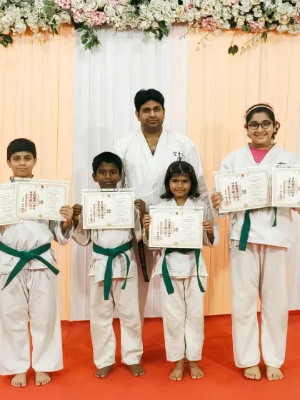 These students have all earned their green belts, an important intermediate step in their karate training. This level requires a solid understanding of more complex katas and techniques.
