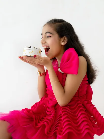 A moment of pure excitement and anticipation before taking a bite of the birthday cake. I love capturing these expressive moments.