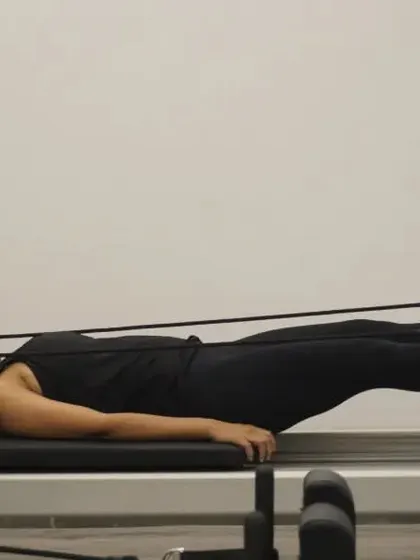 Feet in straps, holding a low hover. This is an intense core exercise that builds incredible abdominal strength.