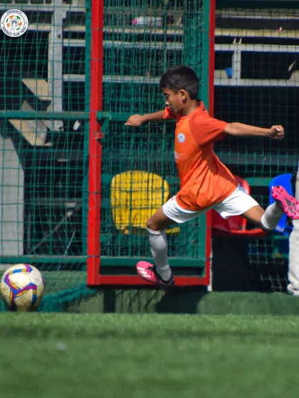 A player unleashes a powerful shot on goal. We train our players to be decisive and clinical in the final third.