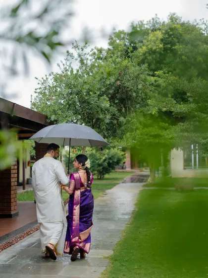 A romantic stroll in the rain. We embrace every element of the wedding day, even a little monsoon magic, to create unique and memorable couple portraits.