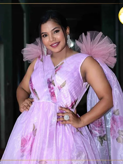 A vibrant and modern party look. The makeup is fresh and luminous, with a pop of color on the lips to match the cheerful vibe of the floral lavender dress.