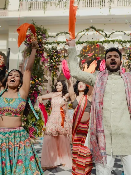 A duplicate of image 161, capturing the vibrant energy of a daytime group performance with colorful props.