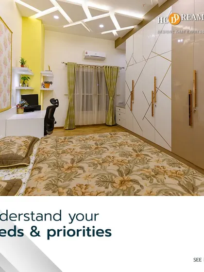 This bedroom design focuses on understanding the client's needs. It includes a dedicated workspace, ample wardrobe storage with geometric gold inlays, and a comfortable bed, all in a bright, cheerful color scheme.