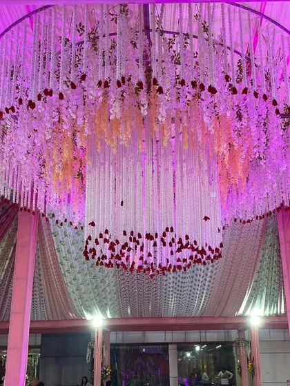 Another angle of the floral chandelier, showcasing its scale and the beautiful way it catches the light.