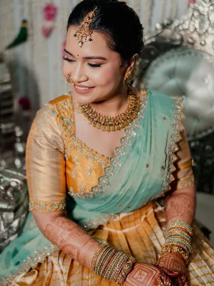 A happy and glowing bride. This close-up shows the smooth, skin-like finish of the makeup and the soft smile that completes the look.