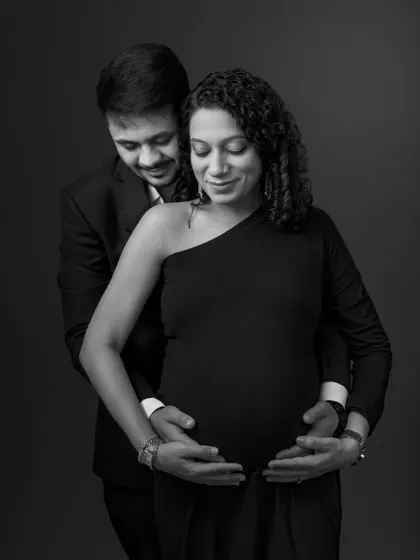 A duplicate of the intimate couple's portrait, focusing on the hands that protect and cherish the new life.
