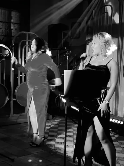 Another angle of the live duo, showcasing their dynamic stage presence that gets the whole room engaged.