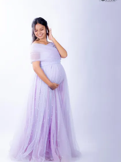 A full-length view of the Breezy gown. The A-line skirt is light and airy, and the scattered pearls add a touch of subtle sparkle.