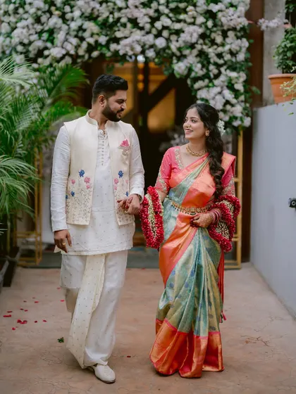 The happy couple, Gayatri and Saurabh, walking hand-in-hand after their engagement ceremony.