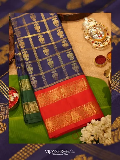A festive flat-lay of the Ganga Jamuna border saree, a perfect choice for Varamahalakshmi puja.