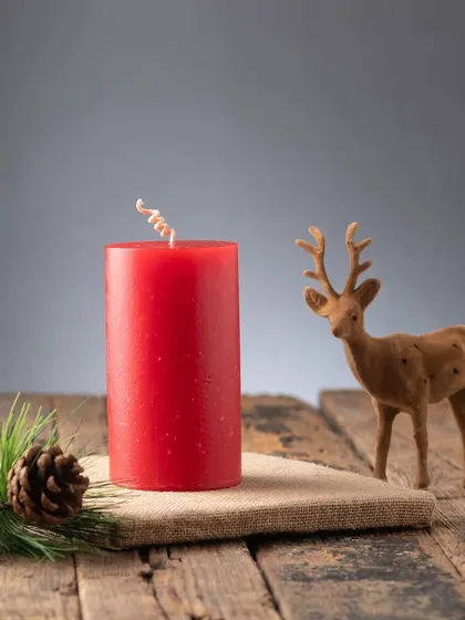 A classic red pillar candle, perfect for any Christmas decor. The curled wick adds a little touch of whimsy.