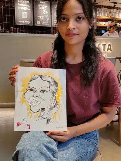 Another guest from the Costa Coffee event, posing with her unique artwork.