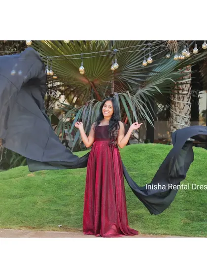 Another pose with the maroon shimmer gown, showing how the black trail can be styled for different dramatic effects.