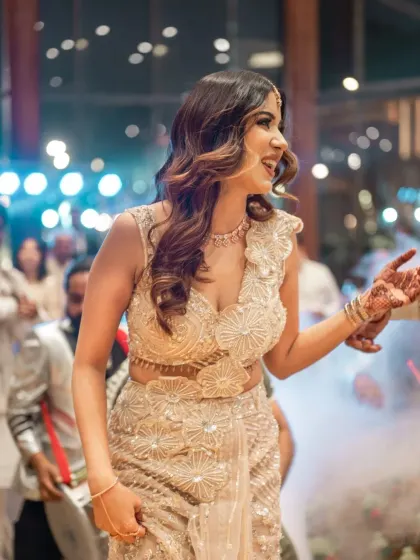 The bride-to-be dances with joy, a candid shot capturing the energy and happiness of the engagement party.