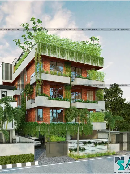Designed for a lush plot in Noida, this residence embraces nature. The facade uses exposed red brick cladding and integrates several full-grown trees and layered planters, seamlessly blending the structure with its green surroundings.