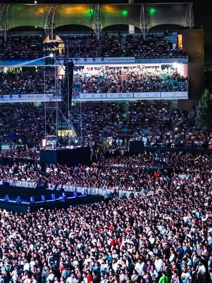 Another view of the immense crowd, stretching back to the upper levels of the stadium. Our sound engineering ensures that every note is heard with perfect clarity, no matter where you are seated.