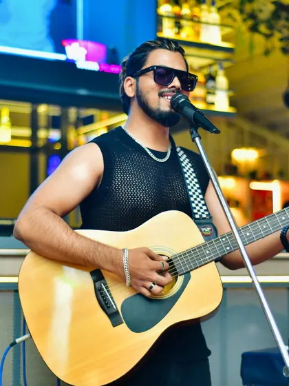 Another look from a live show, guitar in hand and ready to entertain. My style is modern, energetic, and always focused on the audience.