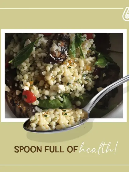 A spoonful of our healthy couscous salad, showing the fine texture and fresh ingredients. It's a perfect example of a meal that is both light and packed with nutrients.