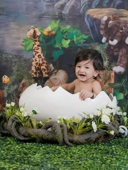 Welcome to the jungle! This little one is having a wild time in our jungle-themed setup, complete with a hatching egg and plush animal friends.