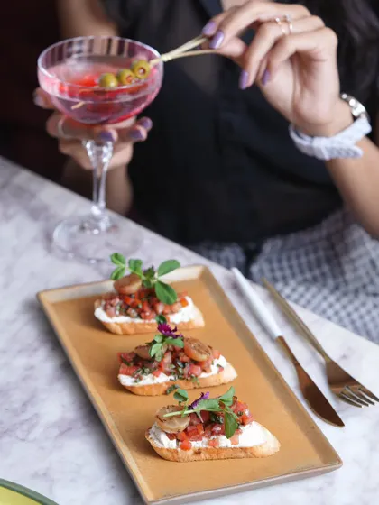 Classic bruschetta with a twist, paired with a vibrant pink cocktail. A perfect start to any meal at my house.