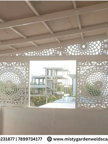 A view from inside the terrace, looking out through the intricately cut CNC panels. The design allows for light and views while creating a beautiful decorative element.