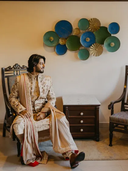 A pensive and stylish portrait of the groom seated before the ceremony. The composition and lighting reflect our architectural approach to creating structured, impactful images.