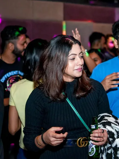 A guest enjoying a beer and the music, soaking in the Christmas party vibes.