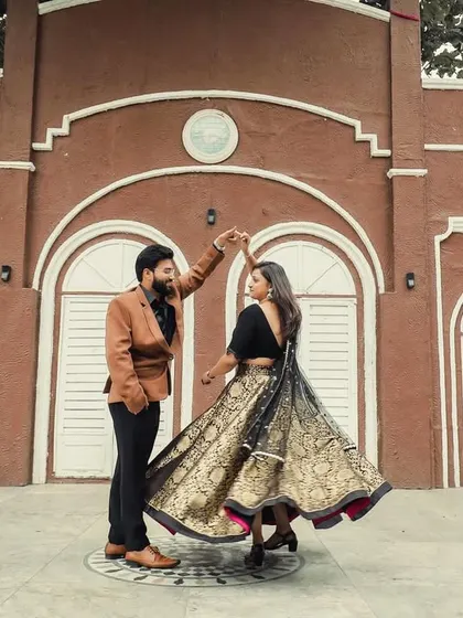 Another angle of the couple's dance, capturing the beautiful motion and intricate design of the bride's lehenga.