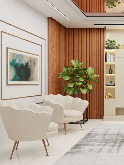 The seating area in this living room features elegant shell-backed armchairs and a large, comfortable sofa. The framed abstract art and fiddle-leaf fig plant add touches of sophistication and nature to the space.