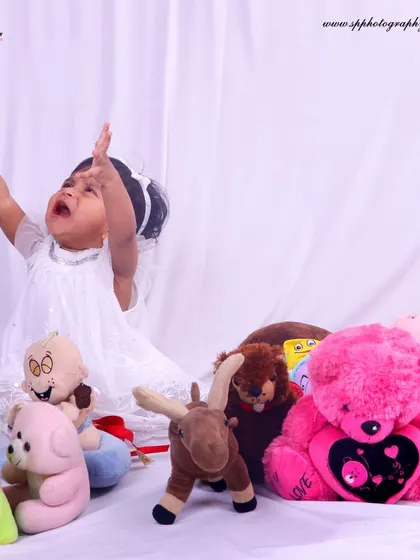 Sometimes the most memorable photos are the most candid ones. This shot of a baby mid-cry, surrounded by toys, is a real and honest moment of childhood that tells a story.