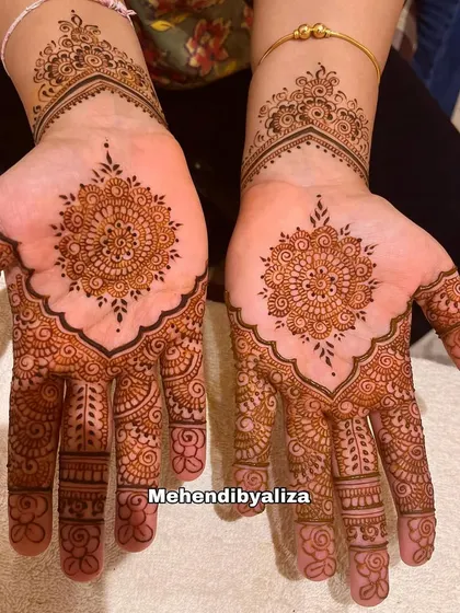 Simplicity meets henna magic. This design features a classic mandala on the palm, a timeless choice that is always elegant.