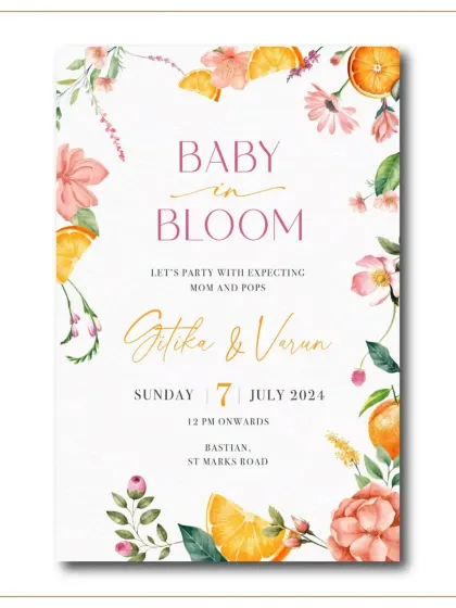 A 'Baby in Bloom' invitation for a floral-themed baby shower. The card is adorned with a border of watercolor oranges and pink flowers, creating a fresh and vibrant look.