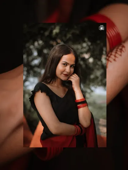 A simple yet elegant portrait in a red and black saree. The creative framing adds an artistic touch, drawing the viewer's eye to the model's gentle expression.