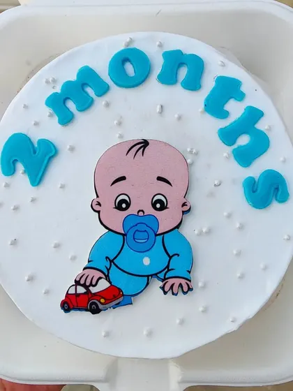 A two-month milestone bento cake with a cute baby illustration.