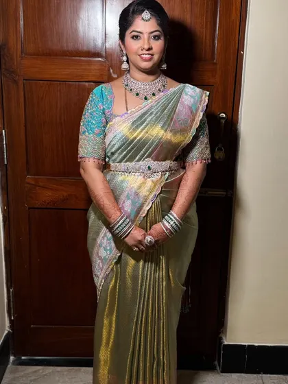 Ashritha looking radiant for her brother's reception. This full-length shot shows how our complete makeover service creates a polished and elegant final look.