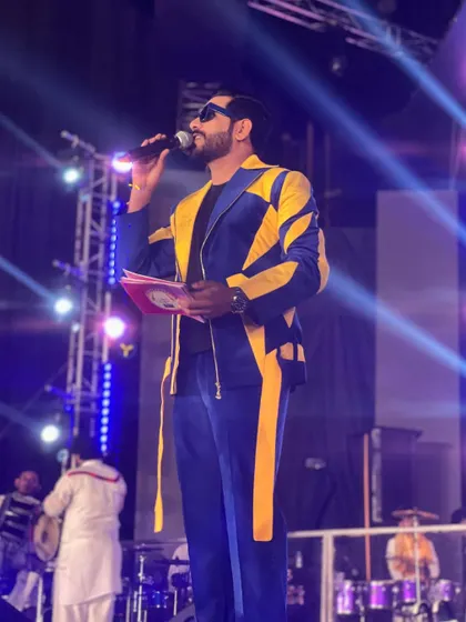 On the mic at Rangraas Navratri. A striking outfit gives me the confidence to command the stage and connect with the massive audience.
