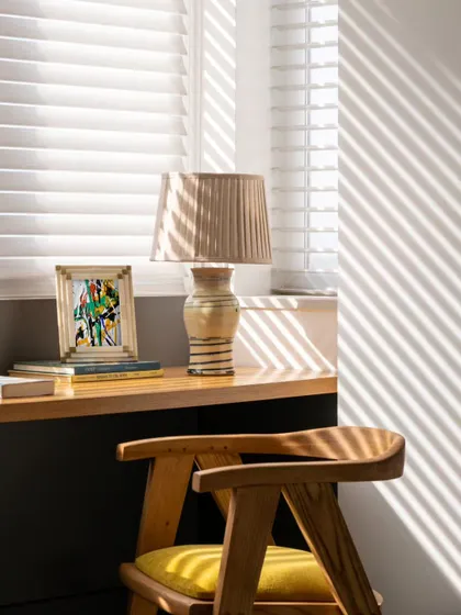 A close-up of the study alcove, where sunlight casts dynamic shadows across the desk. This detail highlights the serene and contemplative mood of the space, perfect for focused work.