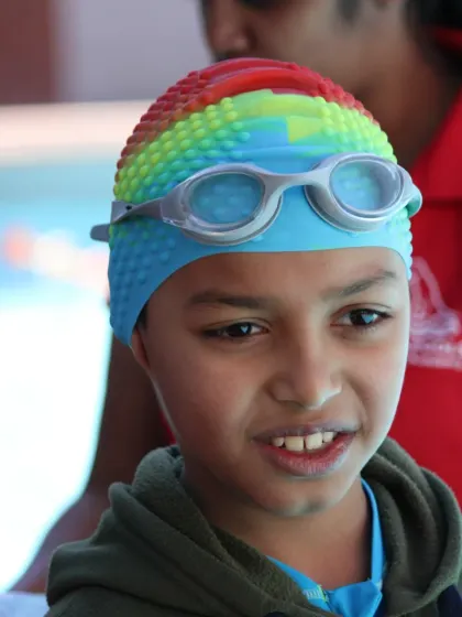 A close-up of a young swimmer, focused and ready for the next drill. We teach children to be attentive and disciplined, skills that help them both in and out of the water.