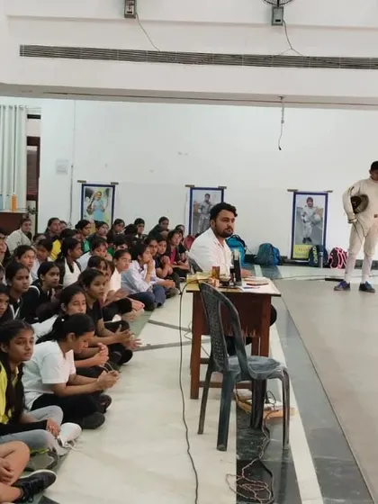 Our head coach addresses a hall full of attentive students. These group sessions are vital for discussing strategy, sharing lessons from competitions, and reinforcing our club's values.