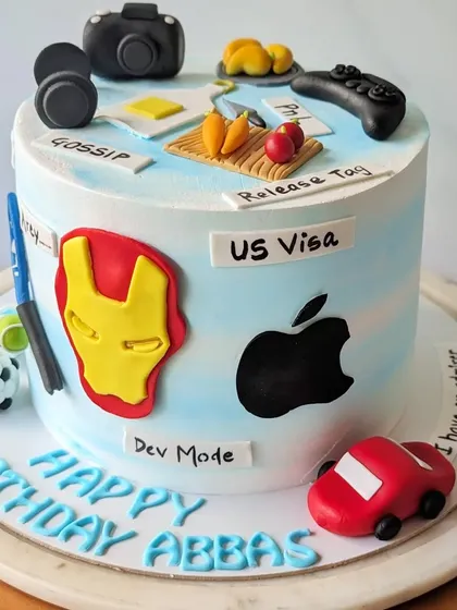 The third view of this highly detailed cake shows a camera, headphones, and a small car. Grouping multiple personal elements together is a great way to celebrate everything that makes a person unique.