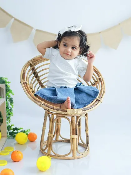 A playful and confident pose from this little fashionista. The simple setup allows her personality and cute outfit to shine.