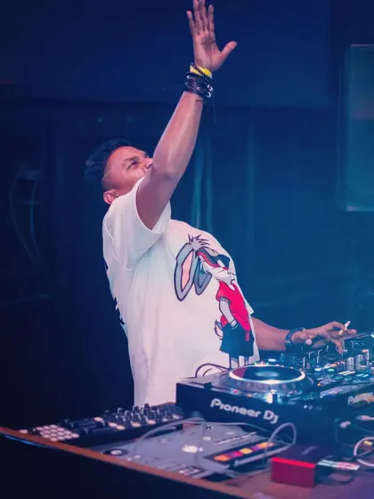 Hands up for the music. A moment of pure joy and connection with the crowd during a high-energy progressive house set.