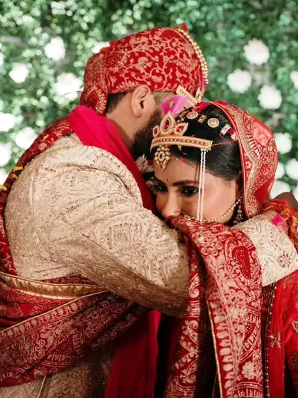 A tender embrace after the completion of the wedding rituals. This photograph captures the emotional culmination of the ceremony and the beginning of their new journey.