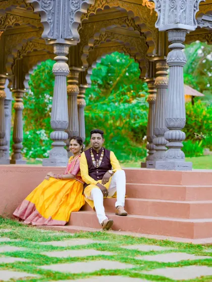 A relaxed and romantic pose on the steps of a beautiful gazebo. The traditional outfits look stunning against the natural and architectural elements.