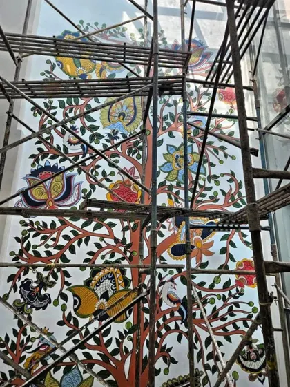 Another perspective of the massive Kalamkari mural, showing the vibrant colors and detailed patterns of the Tree of Life taking shape.